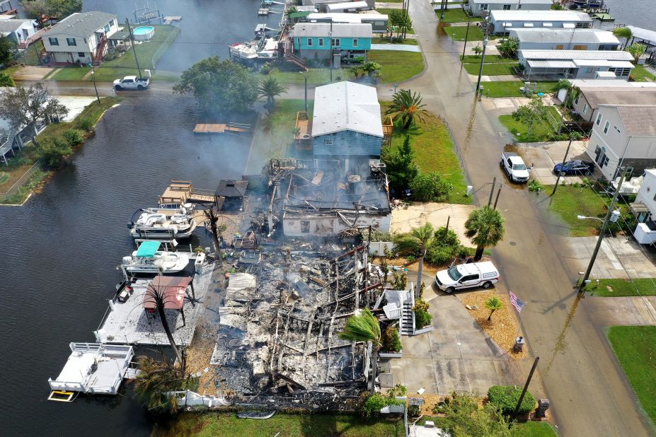 Floodwaters surround the remains of a smoldering home in Hudson, Florida, on August 30. 