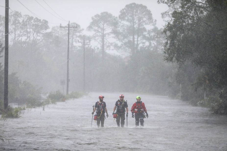 Rescue workers walk through water in Steinhatchee, looking for people in need of help on August 30.