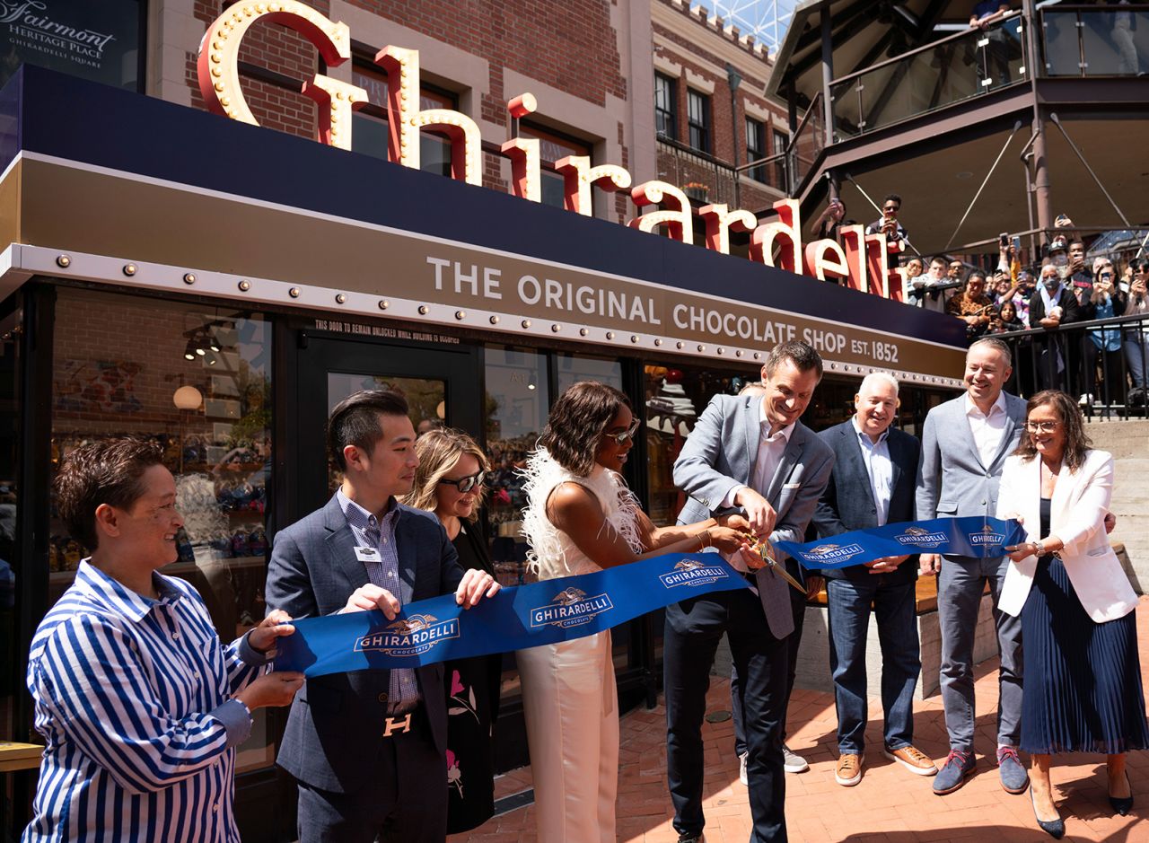 IMAGE DISTRIBUTED FOR GHIRARDELLI -- Grammy Award winning sensation Kelly Rowland and Ghirardelli Chocolate Co. CEO Joel Burrows seen at the grand reopening of The Original Ghirardelli Chocolate & Ice Cream Shop at Ghirardelli Square on Tuesday July 13, 2023 in San Francisco. Rowland helped cut the ribbon for the 171-year-old chocolate company. The reimagined flagship Ghirardelli store showcases North America's largest flowing chocolate wall, a San Francisco Cable Car replica that serves as a seating area, and 15 sundae varieties, including the World Famous Hot Fudge Sundae. (Don Feria/AP Images for Ghirardelli)