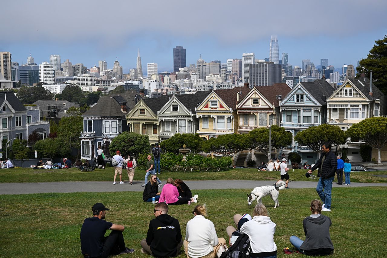 CALIFORNIA, UNITED STATES - AUGUST 9: People spend time in front of the famous Victorian houses called 'Painted Ladies' at Alamo Square in San Francisco, California, United States on August 9, 2023. (Photo by Tayfun Coskun/Anadolu Agency via Getty Images)