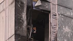 TOPSHOT - A woman inspects the damage sustained to a building of the Moscow International Business Center (Moskva City) following a drone attack in Moscow on August 23, 2023. A Ukrainian drone attack on Moscow damaged a building in a central business district, authorities said on August 23, in the sixth straight night of aerial attacks on Russia's capital region. (Photo by NATALIA KOLESNIKOVA / AFP) (Photo by NATALIA KOLESNIKOVA/AFP via Getty Images)