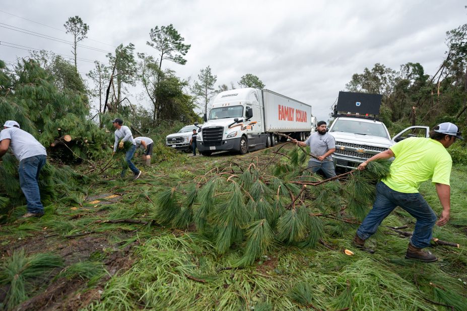 People work to clear I-10 of fallen trees near Madison, Florida, on August 30.