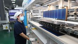 An employee works on the production line of solar panels at a photovoltaic enterprise on August 28, 2023 in Lianyungang, Jiangsu Province of China.