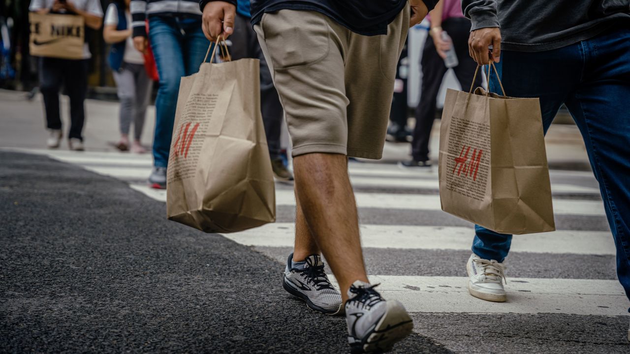 Shoppers carry retail bags along the Magnificent Mile shopping district in Chicago, Illinois, US, on Tuesday, Aug. 15, 2023. US retail sales rose in July by more than forecast, suggesting consumers still have the wherewithal to sustain the economic expansion. Photographer: Jamie Kelter Davis/Bloomberg via Getty Images