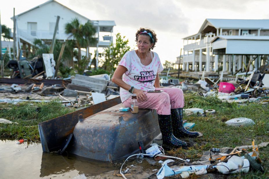 Jewell Baggett sits on a bathtub amid the wreckage of the home built by her grandfather, where she grew up and three generations of her family lived, in Horseshoe Beach on August 30.