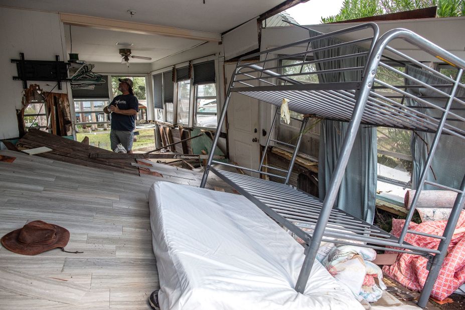 A person looks at the damage inside a destroyed house in Horseshoe Beach on August 30.