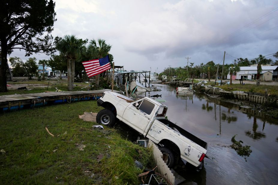 A pickup truck sits halfway into a canal in Horseshoe Beach on August 30.