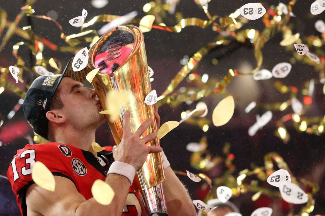INGLEWOOD, CALIFORNIA - JANUARY 09: Stetson Bennett #13 of the Georgia Bulldogs celebrates by kissing the College Football Playoff National Championship Trophy after defeating the TCU Horned Frogs in the College Football Playoff National Championship game at SoFi Stadium on January 09, 2023 in Inglewood, California. Georgia defeated TCU 65-7. (Photo by Ezra Shaw/Getty Images)