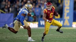 PASADENA, CALIFORNIA - NOVEMBER 19: Austin Jones #6 of the USC Trojans runs with the ball as he is chased by Grayson Murphy #12 of the UCLA Bruins at Rose Bowl on November 19, 2022 in Pasadena, California. (Photo by Harry How/Getty Images)