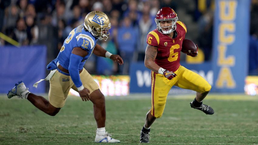 PASADENA, CALIFORNIA - NOVEMBER 19: Austin Jones #6 of the USC Trojans runs with the ball as he is chased by Grayson Murphy #12 of the UCLA Bruins at Rose Bowl on November 19, 2022 in Pasadena, California. (Photo by Harry How/Getty Images)