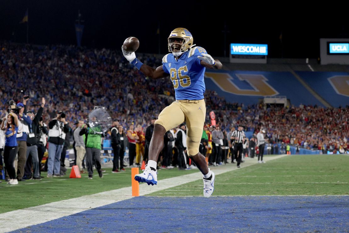 PASADENA, CALIFORNIA - NOVEMBER 19: Michael Ezeike #86 of the UCLA Bruins celebrates after scoring a touchdown against the USC Trojans during the first quarter in the game at Rose Bowl on November 19, 2022 in Pasadena, California. (Photo by Harry How/Getty Images)