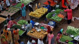 Customers buy fruits and vegetables at an open air evening market in Ahmedabad, India, August 21, 2023. REUTERS/Amit Dave