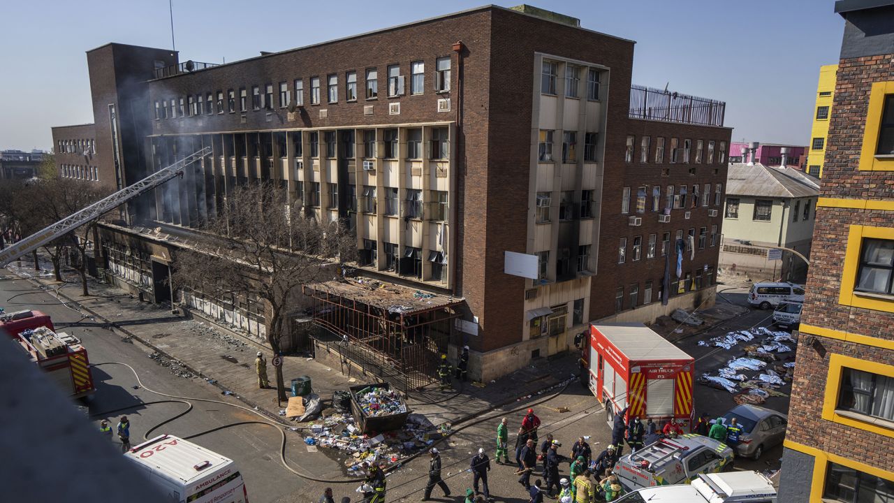 Medics and emergency works at the scene of a deadly blaze in downtown Johannesburg Thursday, Aug. 31, 2023. Dozens died when a fire ripped through a multi-story building in Johannesburg, South Africa's biggest city, emergency services said Thursday. (AP Photo/Jerome Delay)