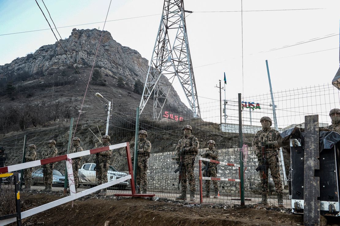 Azerbaijani servicemen stand guard at a checkpoint at the Lachin corridor, which links Nagorno-Karabakh with Armenia.