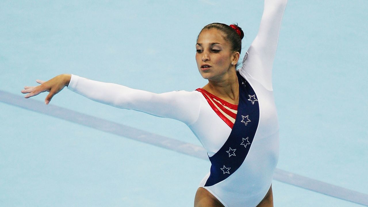 ATHENS - AUGUST 17: Mohini Bhardwaj of the United States competes in the floor excersize at the women's artistic gymnastics team final competition on August 17, 2004 during the Athens 2004 Summer Olympic Games at the Olympic Sports Complex Indoor Hall in Athens, Greece. (Photo by Andy Lyons/Getty Images)