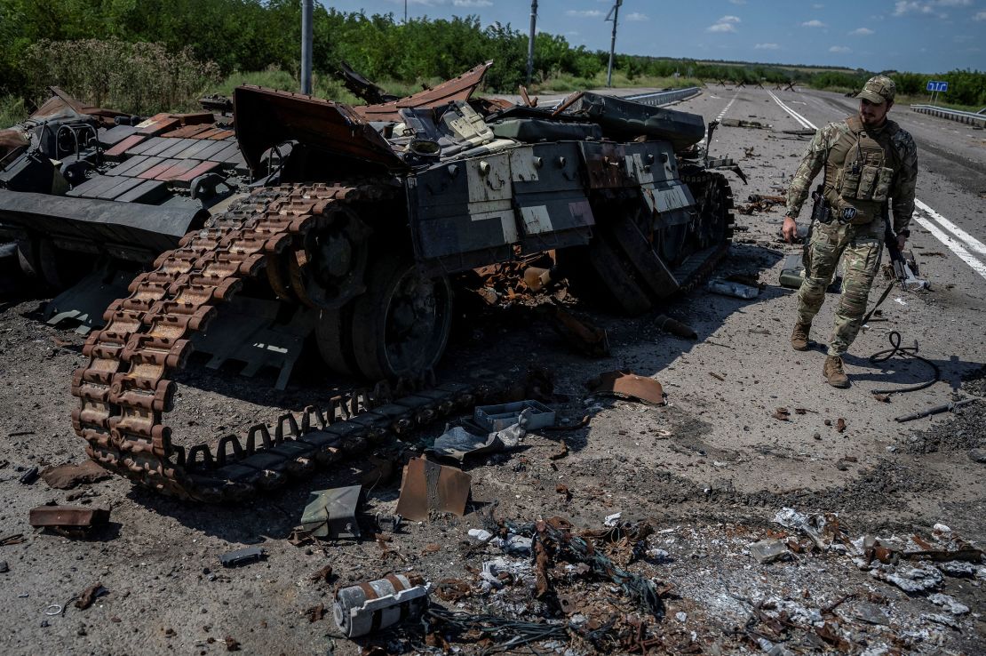 A Ukrainian serviceman walks near a destroyed Ukrainian tank near Robotyne in the Zaporizhzhia region, on August 25, 2023. 