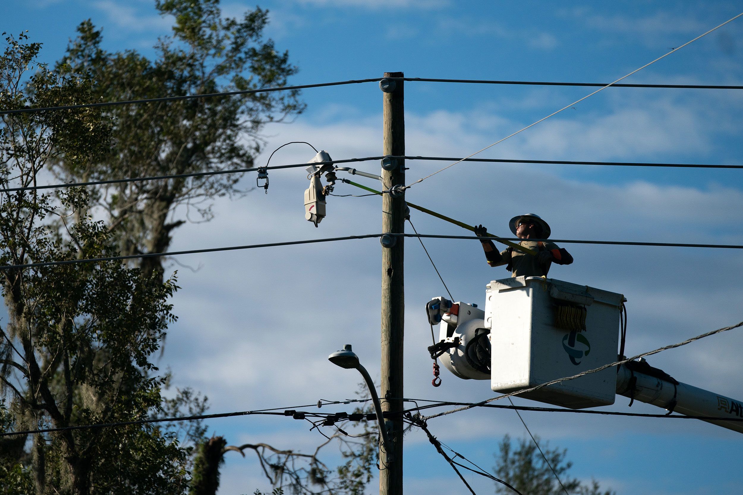 A lineman works to restore service on Thursday, August 31, in Perry, Florida.