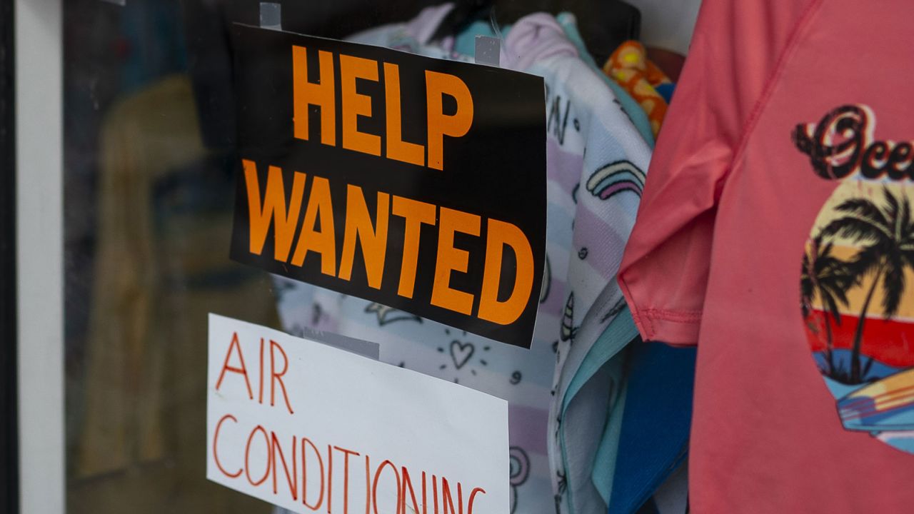 A help wanted sign on a storefront in Ocean City, New Jersey, US, on Friday, Aug. 18, 2023. Surveys suggest that despite cooling inflation and jobs gains, Americans remain deeply skeptical of the president's handling of the post-pandemic economy. Photographer: Al Drago/Bloomberg via Getty Images