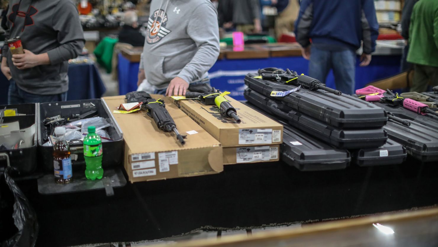 People browse guns for sale during the Novi Gun and Knife Show at Suburban Collection Showplace in Novi, Michigan, in February 2018. 