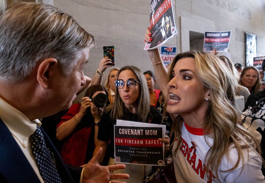 A man argues with Mary Joyce, a mother from the Covenant School, after the Tennessee House Republicans called for a vote to end a special session on public safety to discuss gun violence in the wake of the Covenant School shooting in Nashville, Tennessee, on Tuesday, August 29.