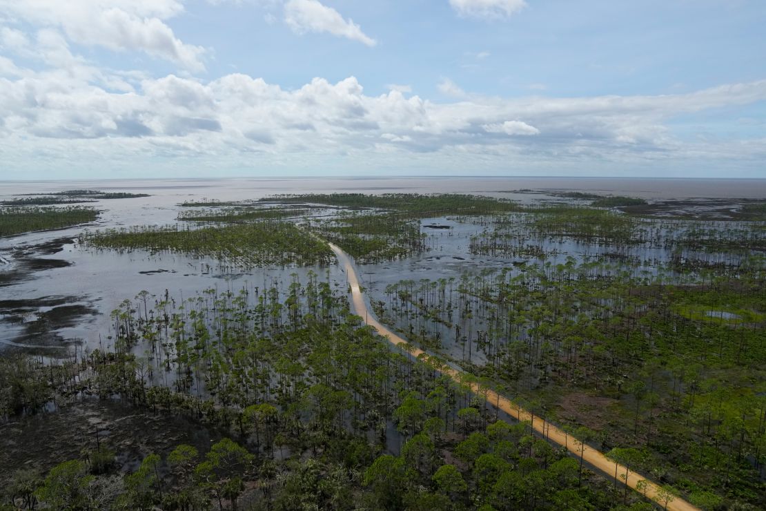 Receding storm waters cover a road near Fish Creek, Florida, after Hurricane Idalia.