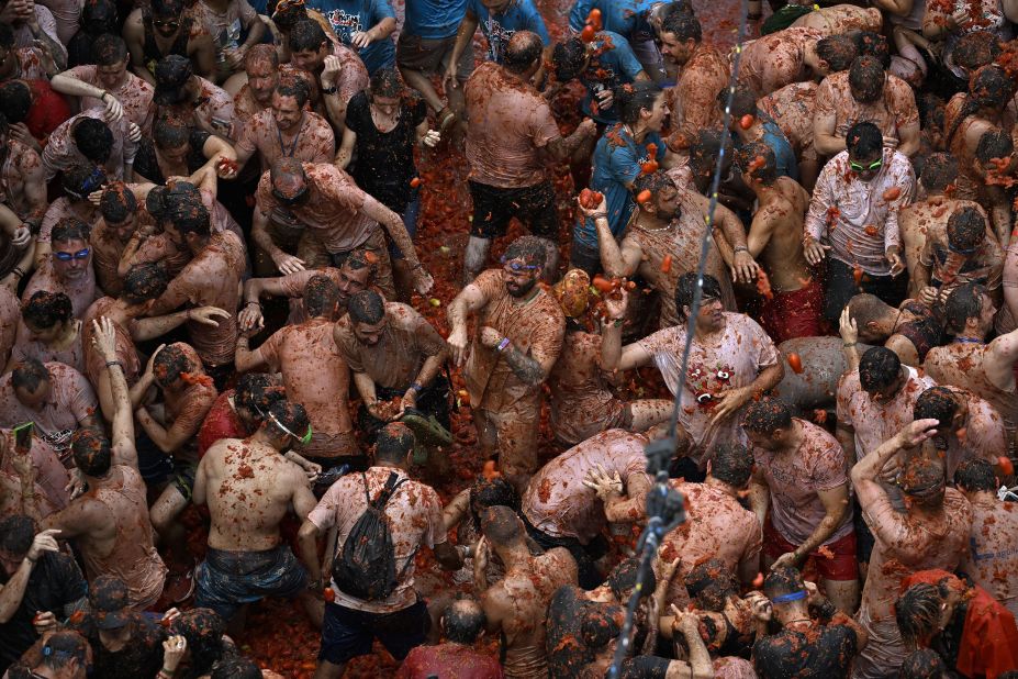 People throw tomatoes at each other during the 76th Tomatina Festival in Bunol, Spain, on Wednesday, August 30. Approximately 15,000 participants threw a total of 120 tons of tomatoes during the festival.