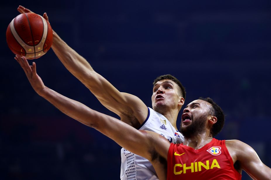 Bogdan Bogdanovic of Serbia blocks a shot by China's Kyle Anderson during a FIBA Basketball World Cup game in Manila, Philippines, on Saturday, August 26.