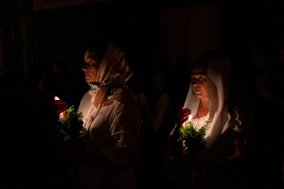 Christian Orthodox women walk in a procession to bring an icon of the Virgin Mary from the Church of the Holy Sepulchure to the tomb where it is believed she is buried ahead of the Feast of Assumption in Jerusalem's Old City early Friday, August 25.