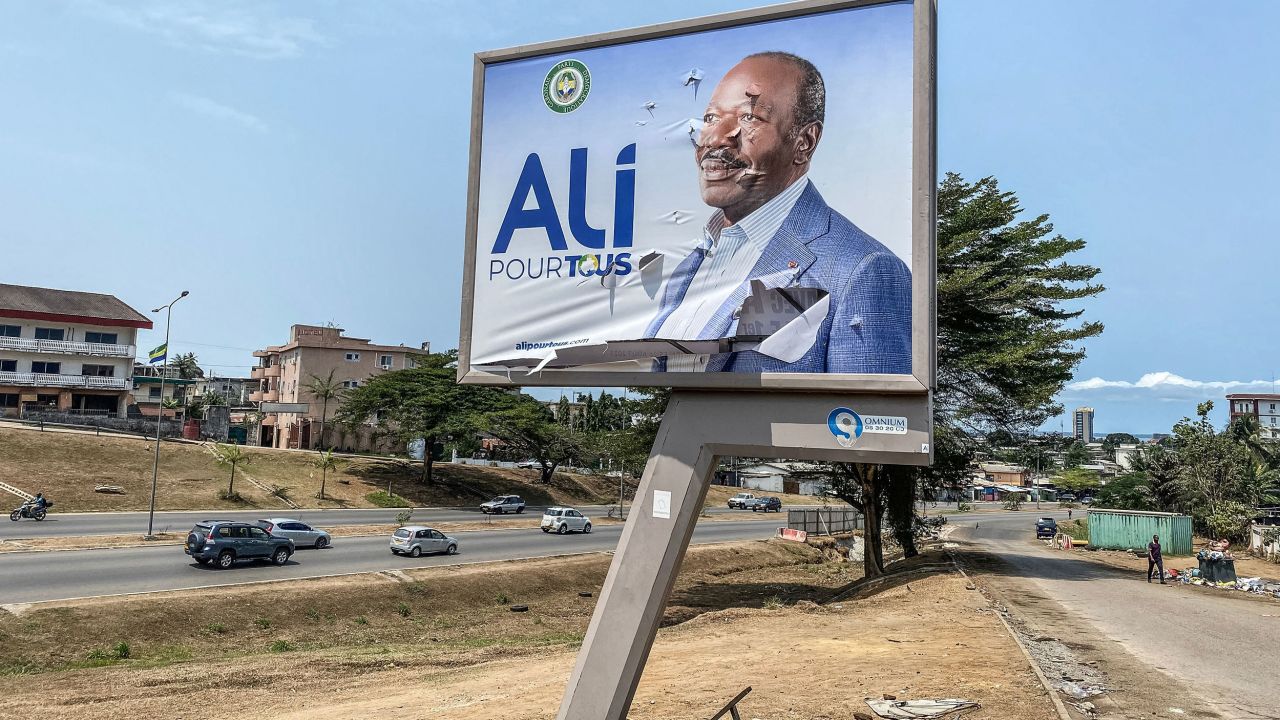 A torn campaign billboard shows ousted Gabon President Ali Bongo Ondimba in Libreville on August 31, 2023.