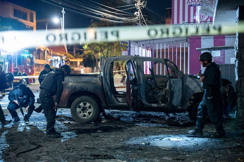 Police inspect a truck that exploded outside an office used by Ecuador's corrections system in Quito early Thursday, August 31. Four car bombs exploded in the country overnight within hours of each other, police said. No one was injured. Ecuador National Police Gen. Pablo Ramírez told reporters the explosions in Quito were related to "several transfers of inmates."