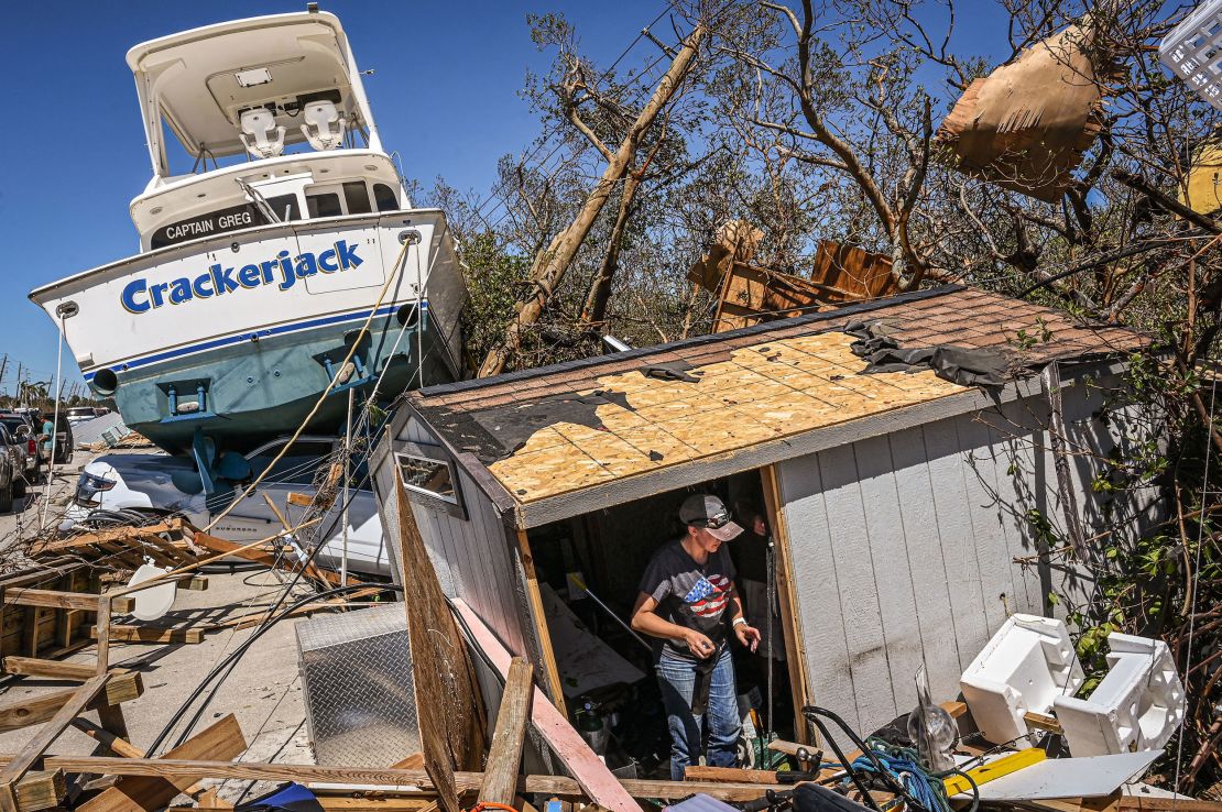 People clear debris in the aftermath of Hurricane Ian in Fort Myers Beach, Florida on September 30, 2022.