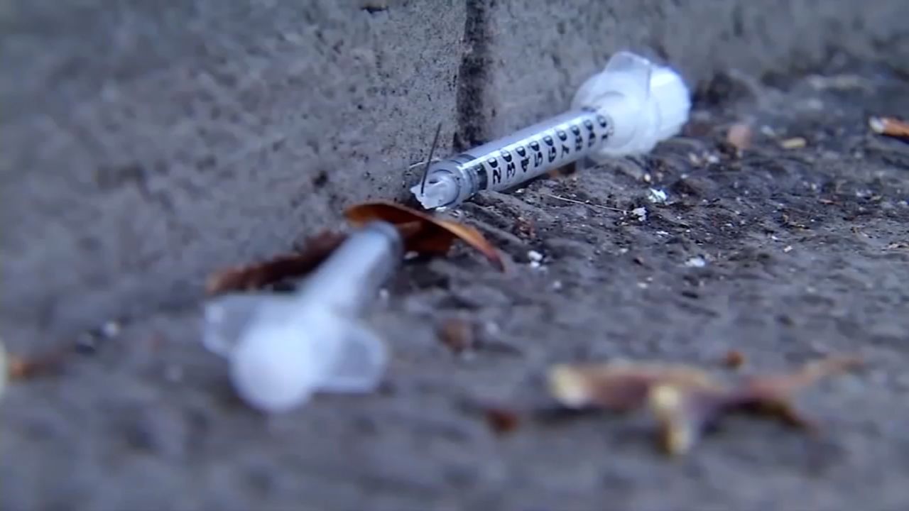 A broken syringe needle is seen on a sidewalk in the Tenderloin District of San Francisco, California.