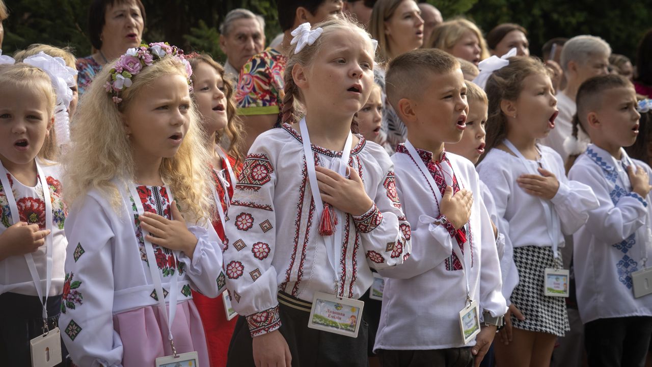 Students sing Ukraine's national anthem as they attend a ceremony of the first day in school in Bucha, on Friday.