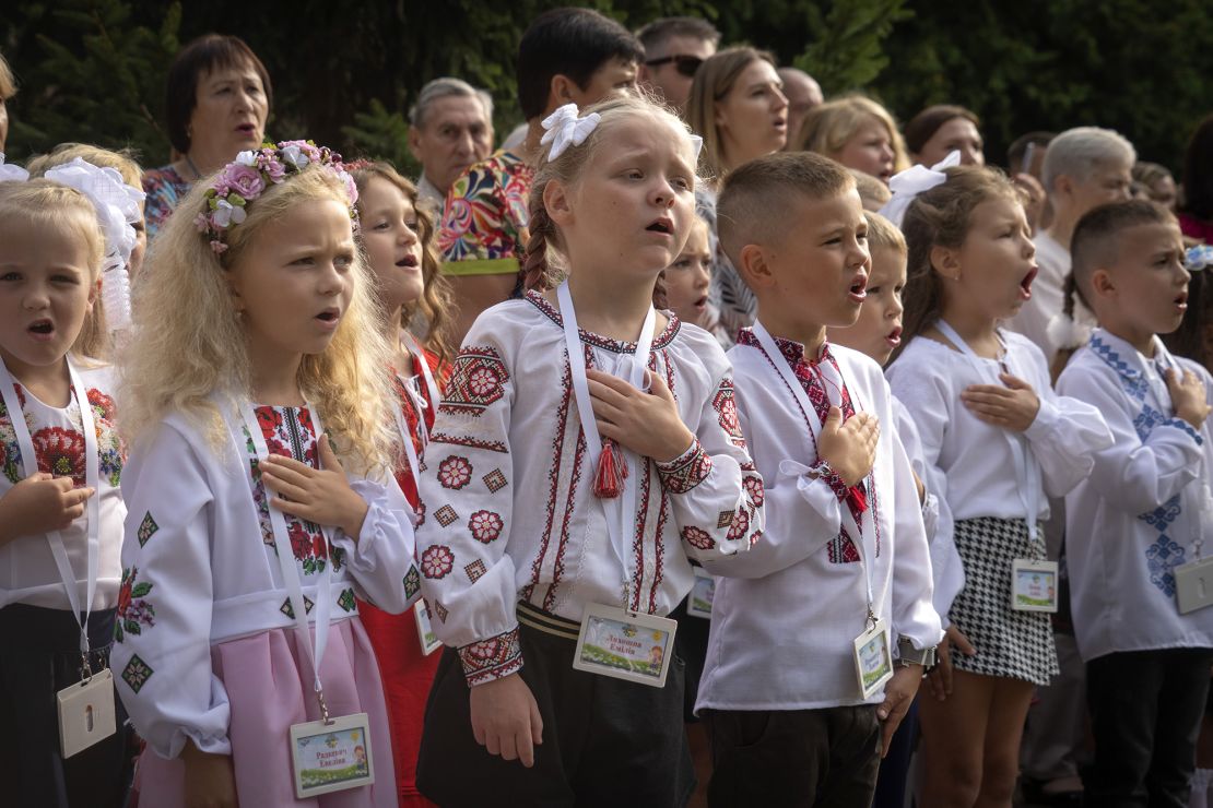 Students sing Ukraine's national anthem as they attend a ceremony of the first day in school in Bucha, on Friday.