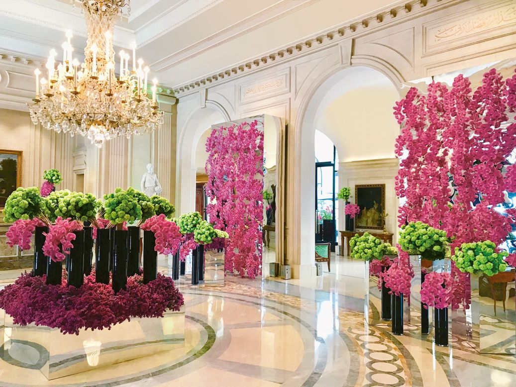 Hot pink viburnum, phalaenopsis orchids, and statice in the lobby of the Four Seasons George V Hotel in Paris.