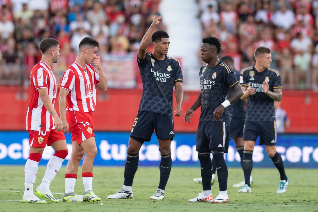 Real Madrid's English midfielder #05 Jude Bellingham (C) celebrates scoring a goal next to Real Madrid's Brazilian forward #07 Vinicius Junior during the Spanish Liga football match between UD Almeria and Real Madrid CF at the Municipal Stadium of the Mediterranean Games in Almeria on August 19, 2023. (Photo by JORGE GUERRERO / AFP) (Photo by JORGE GUERRERO/AFP via Getty Images)