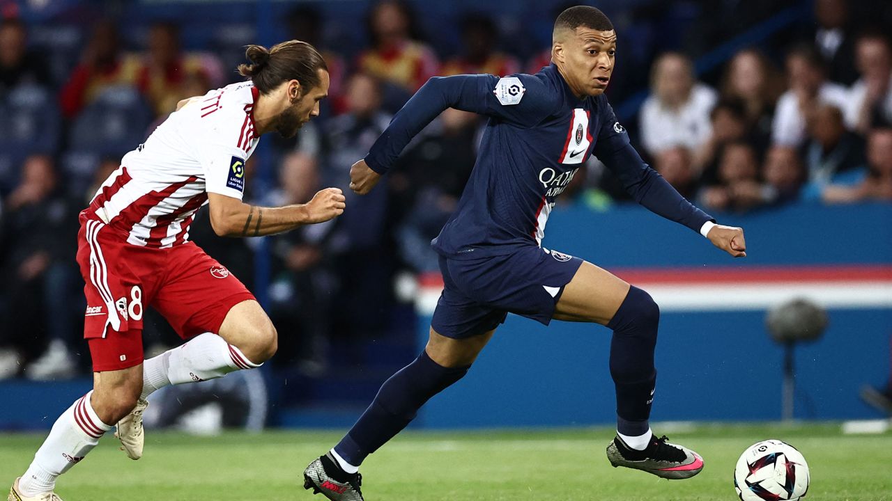 Paris Saint-Germain's French forward Kylian Mbappe (R) fights for the ball with Ajaccio's French midfielder Vincent Marchetti during the French L1 football match between Paris Saint-Germain (PSG) and Ajaccio at the Parc des Princes in Paris, on May 13, 2023. (Photo by Anne-Christine POUJOULAT / AFP) (Photo by ANNE-CHRISTINE POUJOULAT/AFP via Getty Images)