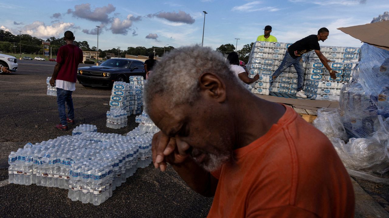 Phillip Young, a local resident from Jackson, Mississippi, takes a break while helping local volunteers distribute bottles of water as the city and areas around it go without reliable drinking water indefinitely after pumps at the water treatment plant failed on August 31, 2022. 