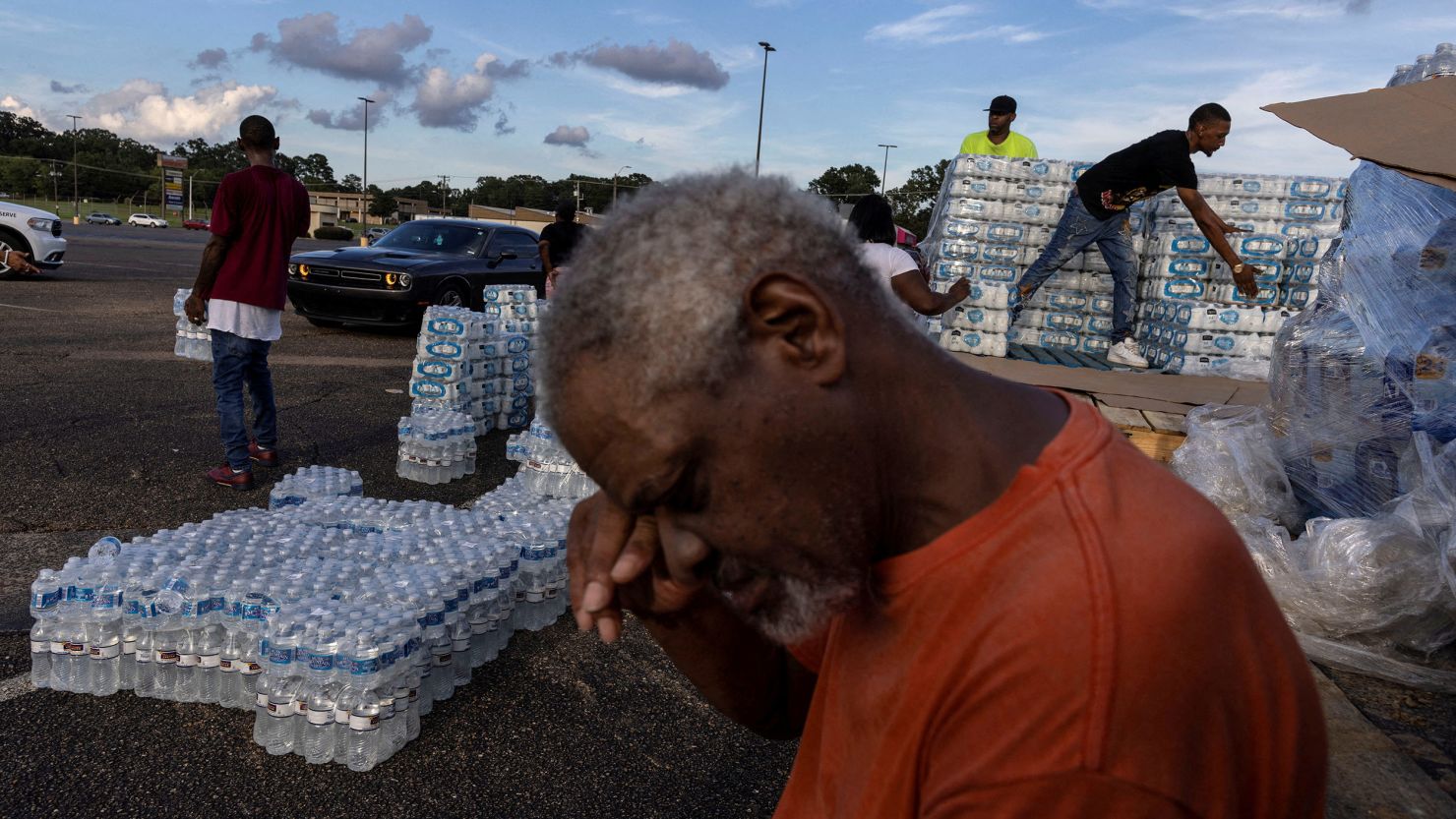 Phillip Young, a resident from Jackson, Mississippi, takes a break while helping volunteers distribute bottles of water during the city's water infrastructure crisis on August 31, 2022. 