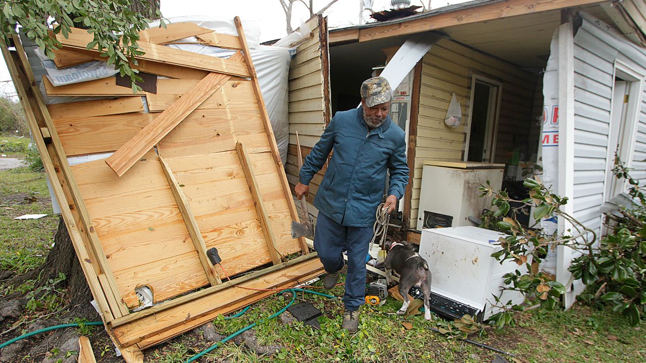 Semler Street resident Mack Robinson checks on his tornado-damaged home in 2012 in Prichard, Alabama. 