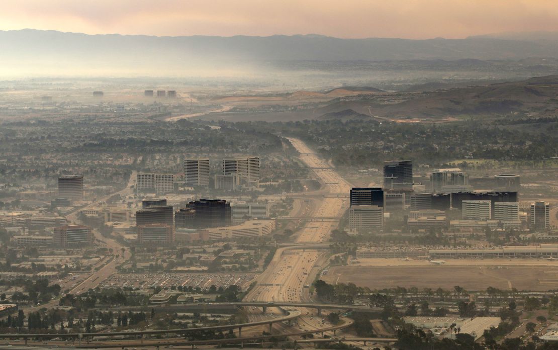 Buildings are seen through the thick smoke of the Santiago Fire in Irvine, California.