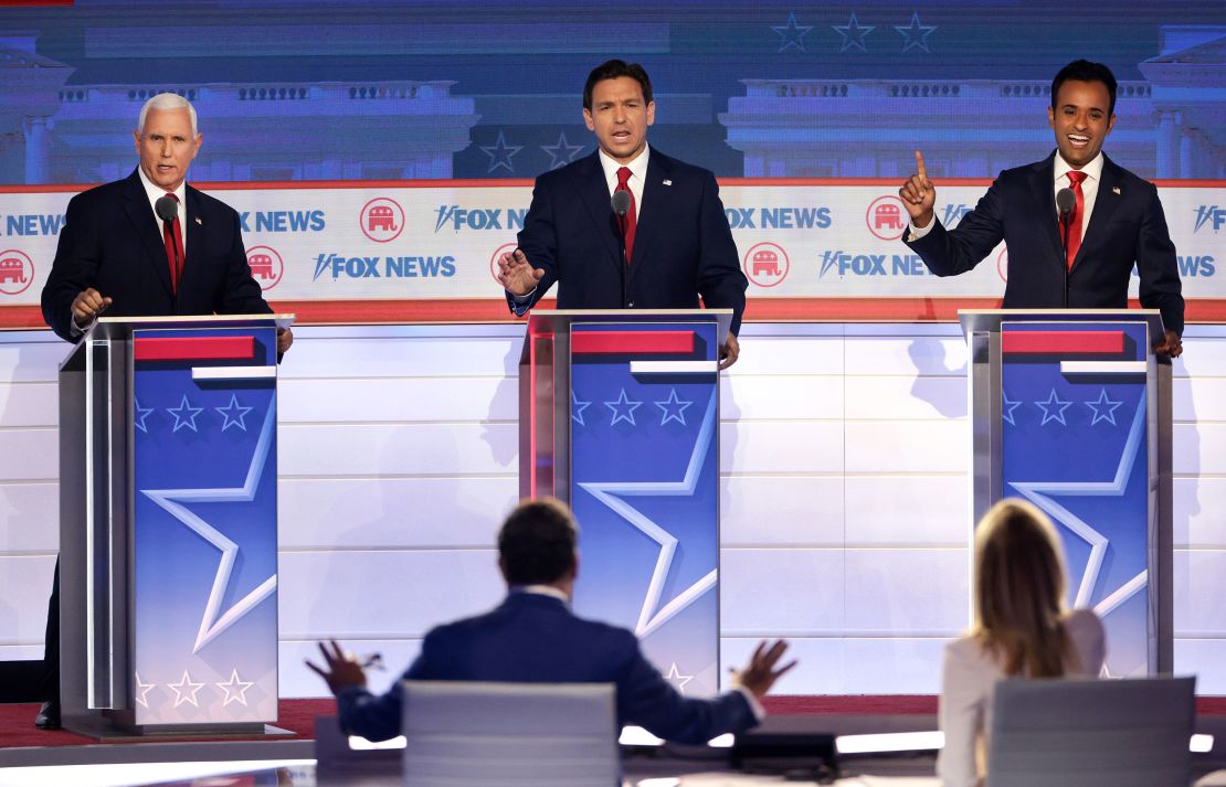 DeSantis, flanked by former Vice President Mike Pence, left, and entrepreneur Vivek Ramaswamy participate in the first GOP primary debate in Milwaukee on August 23, 2023. 