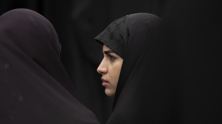 A veiled Iranian woman looks on while attending a religious ceremony in southern Tehran, April 12, 2023. Ahmedreza Radan, Commander-in-Chief of the Police Force, said: ''From April 15, 2023, people who discover the hijab in public roads, cars, and commercial places will be introduced to the judicial authorities.''. (Photo by Morteza Nikoubazl/NurPhoto via Getty Images)