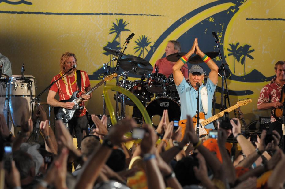 Buffett gives the "fins up" gesture while performing in 2009. 