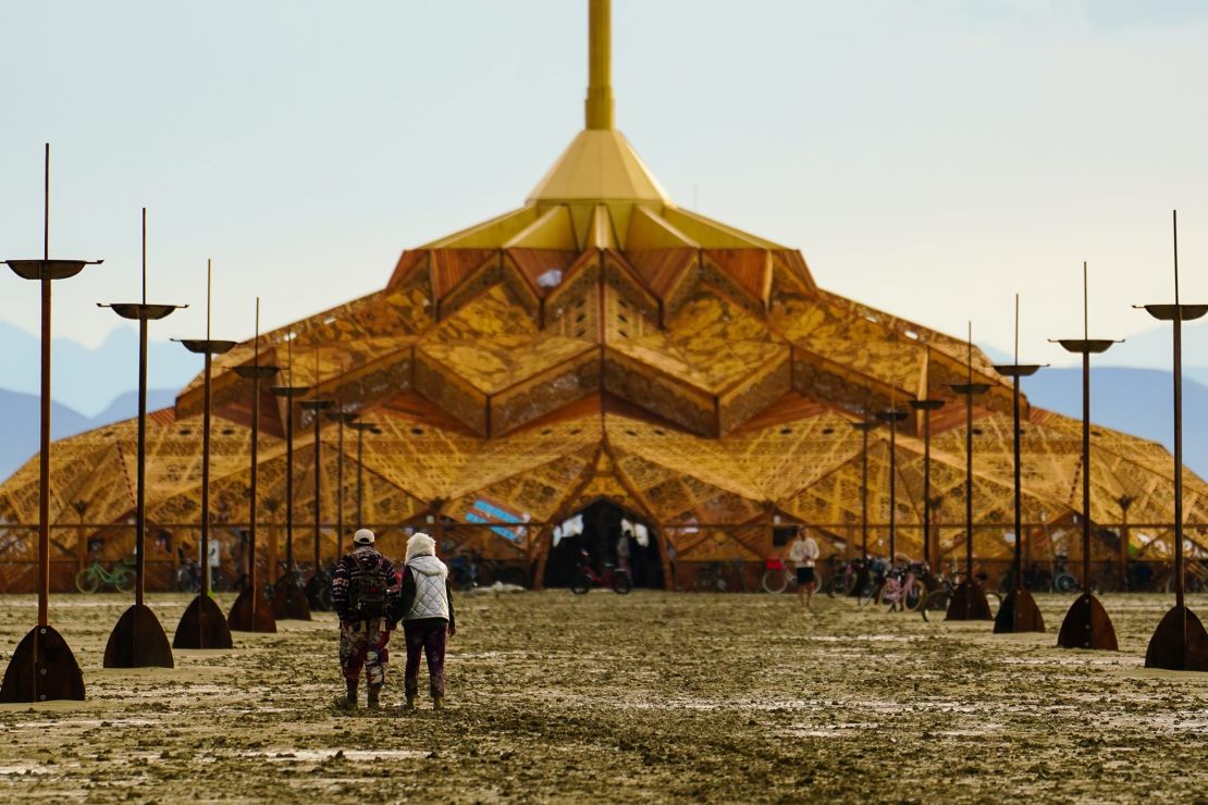 Dawn brought muddy realization to the Burning Man encampment, where the exit gates remain closed indefinitely because driving is virtually impossible.