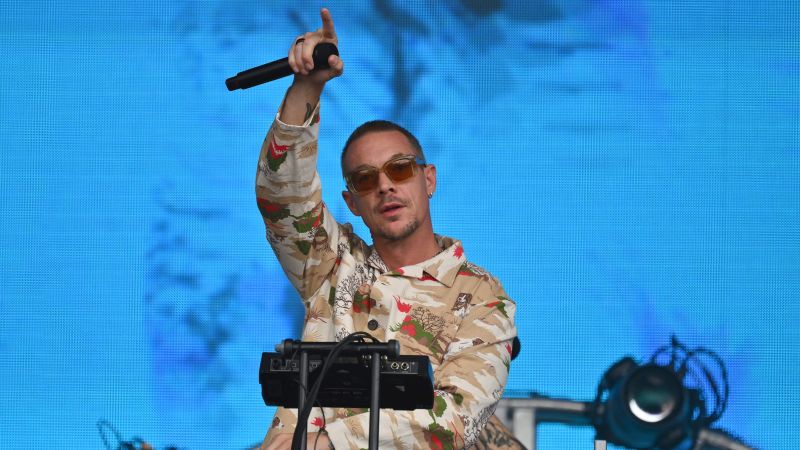 NextImg:Diplo hitchhiked ride out of rain-drenched Burning Man after walking miles 'through the mud' and actually made it to his DC concert | CNN