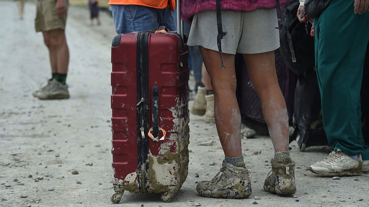 Sep. A man with a muddy suitcase waits to leave the Burning Man site on 3, 2023.