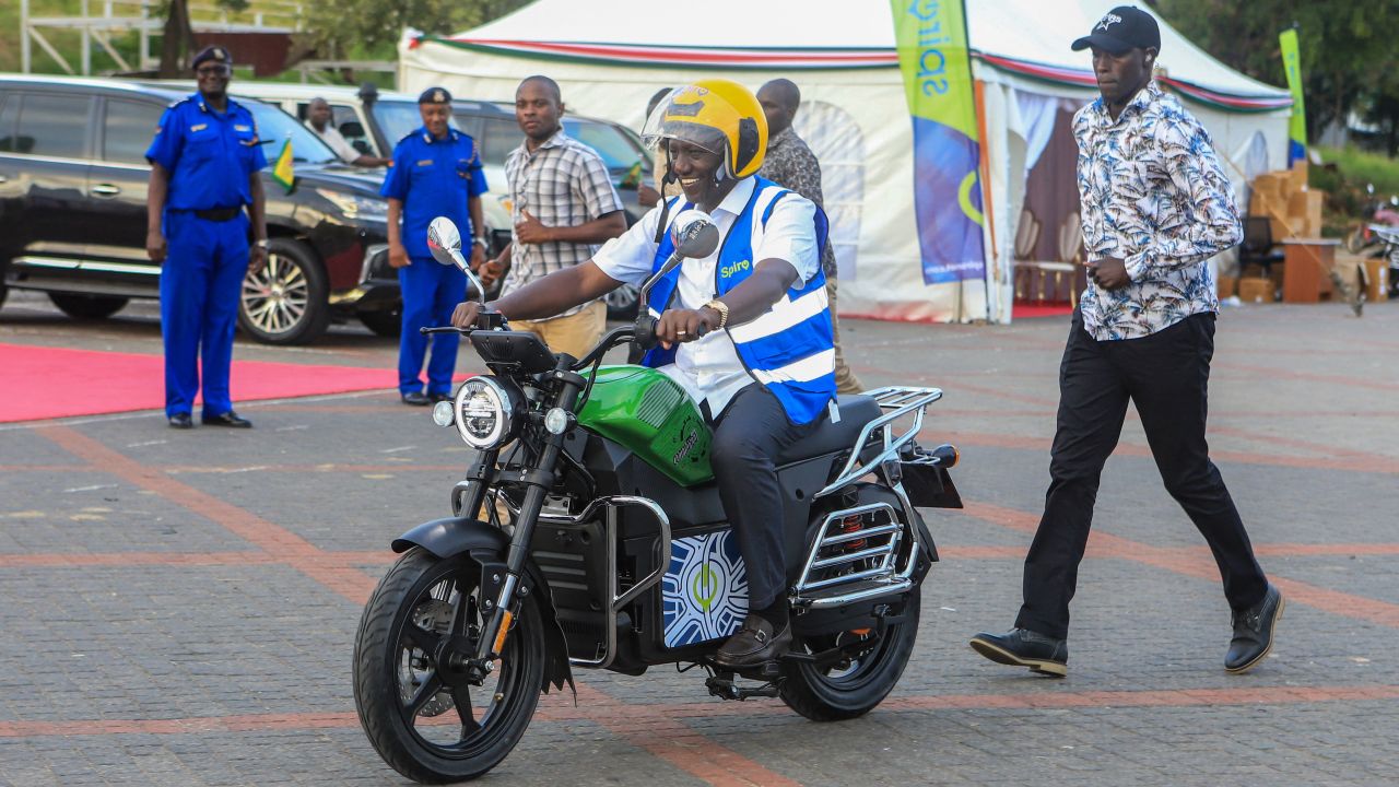 TOPSHOT - Kenya's President William Ruto uses an electric motorcycle during the national launch of an electric motorcycle project dubbed e-bodaboda at Kenyan Coastal city of Mombasa on September 1, 2023. The initiative launched by Kenya's President William Ruto is a collaboration between the Government of Kenya and Spiro, an electric two-wheeler company.This agreement, centred around the delivery of over a million (1.2 million) electric motorcycles and the establishment of more than 3,000 swapping stations in Kenya. (Photo by AFP) (Photo by -/AFP via Getty Images)