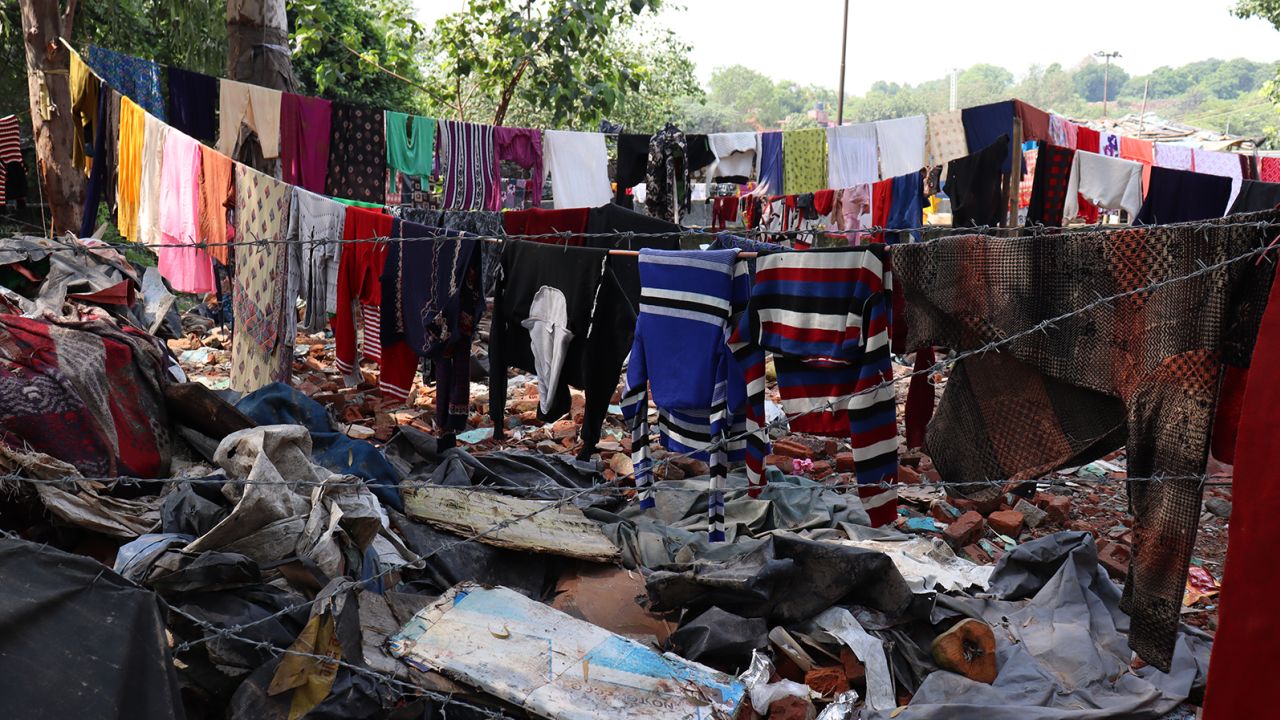 Clothes hanging to dry near demolished houses opposite Pragati Maidan.