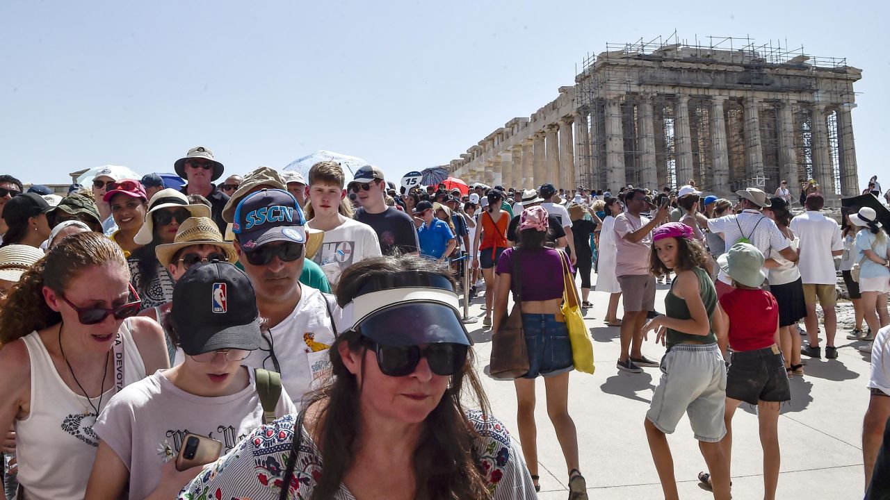 Pictured here: Tourists visit the Parthenon temple at the Athens' Acropolis during the July 2023 heatwave. Going forward, visitors to the Acropolis will be capped at 20,000 a day.